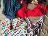 a group of swimsuits laid out on the floor next to each other