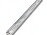 a close up of a metal ruler on a white surface