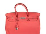 a red leather handbag on a white background