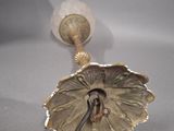 a silver plate with a flower on it on a table