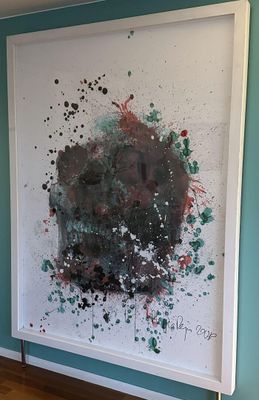 a large painting hanging on the wall in a room