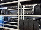 a lot of tires on the shelves in the garage