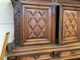 a large wooden cabinet with two doors on top of it