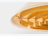 a gold clock that is on a white table