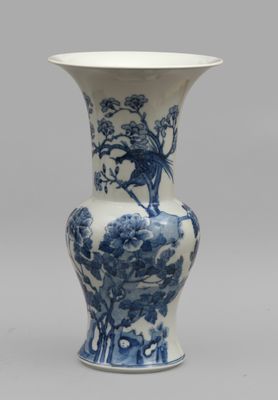 a blue and white vase with a bird on it