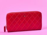 le sac à main matelassé rouge se détache sur un fond rose