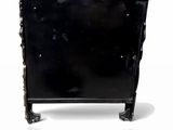 un meuble noir posé sur une surface blanche