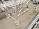 a picture of a metal scaffolding with wheels in a warehouse
