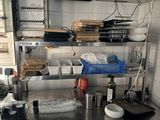 stainless steel counter top in a commercial kitchen with lots of dishes on it