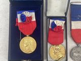 several medals and medals are displayed in a box on a white surface