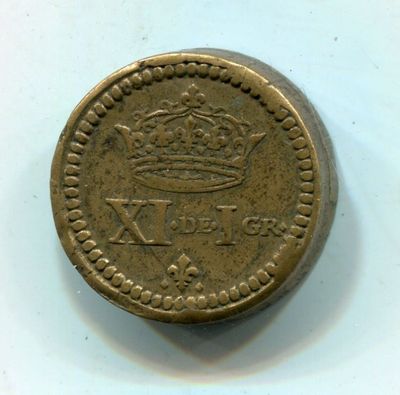 une vieille pièce de monnaie surmontée d'une couronne
