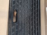 a cardboard box with a piece of black plastic in it