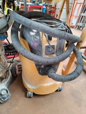 an image of a vacuum and other tools in a garage