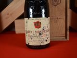 a bottle of wine sitting next to a wooden box