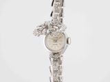 an image of a woman ' s wrist watch with a dragon on it