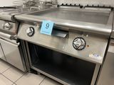 a stainless steel oven with a blue price tag on it
