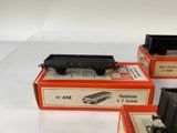 three boxes of toy trains sitting on top of a white surface