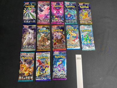 a lot of pokemon cards on the table next to a ruler