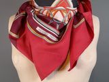 a close up of a mannequin torso with a red scarf on it