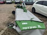 an image of a green and white jet sitting on top of a parking lot
