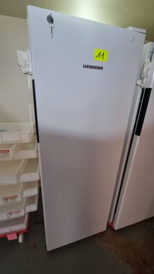 a white refrigerator with a yellow sticker on it