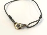 leather cord bracelet with a brass clasp on a white background