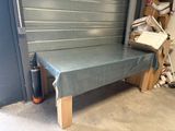 a bench that is covered with a sheet in front of a garage door