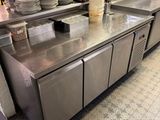 a large stainless steel kitchen with a lot of dishes on the counter