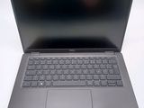 an open laptop computer sitting on top of a white table