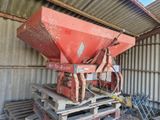 a red machine that is sitting on a pallet