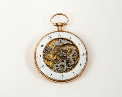an image of a close up of a pocket watch on a white surface