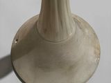 a white vase that is sitting on a table