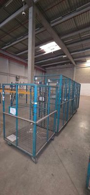 a large metal cage in the middle of a warehouse