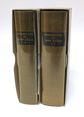 deux livres sont posés l'un sur l'autre sur une surface blanche