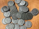 une pile de pièces posée sur une table, avec une étiquette indiquant le prix