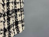 the back of a black and white jacket with a black and white pattern