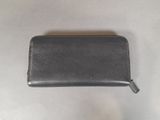 a black leather wallet sitting on top of a white table