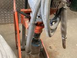 a machine that is sitting on a stand with a hose