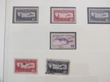 a lot of stamps that are on display in a glass case