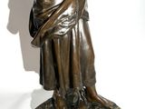 bronze statue of a woman holding a bird in her hand
