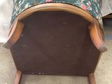 a small foot stool with a floral cover on top of it