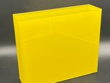 large yellow plastic planter box on a grey background
