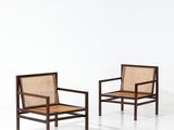 two chairs in a white room with a white floor and a white wall