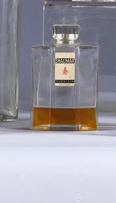 a bottle of perfume next to a bottle of perfume on a table