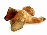 a figurine of a horse laying down on the ground