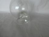 a clear glass bottle with a ring on it
