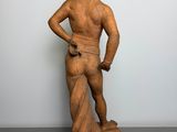 statue of a man with a hat and a bag on his back