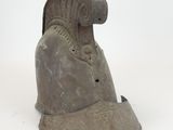 an old helmet is sitting on a white surface with a white background
