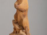 sculpture of a bear sitting on a rock on a table