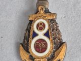 an image of a gold and blue badge on a white surface